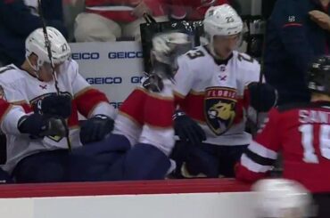 Devils' Santini dumps Panthers' Barkov into his own bench