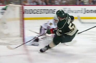 Erik Haula bats bouncing puck past Crawford