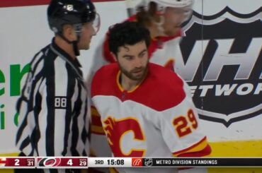 Dillon Dube has his helmet shoved off by Nino Niederreiter