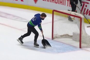 Canucks employee delivers an electric ice scrape