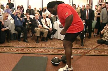 Mark Henry attempts to lift the legendary Thomas Inch Dumbbell with one hand (WWE Network)