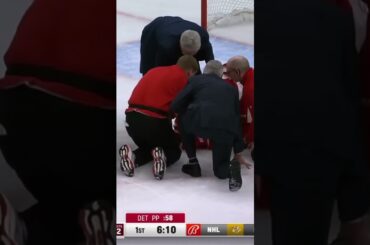 Dylan Larkin lays motionless on the ice, injury