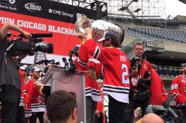 Duncan Keith hands the Stanley Cup to Teuvo Teravainen at the Blackhawks rally