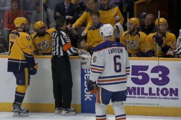 Referee Tim Peel gets repairs from Predators bench, stays in game